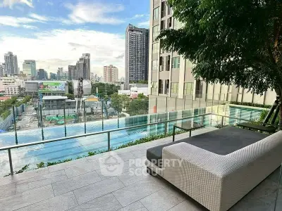 Luxurious urban balcony with stunning city view and poolside relaxation area.