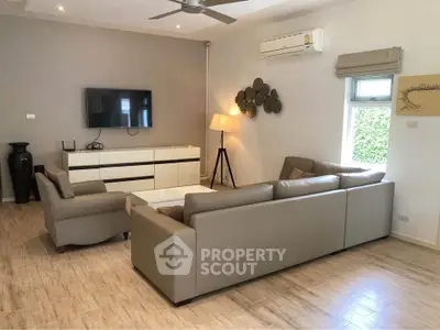 Spacious modern living room with sleek furniture and natural light