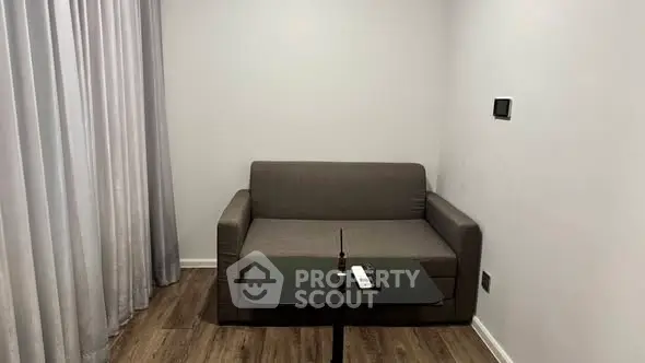 Cozy small living room with modern sofa and sleek table