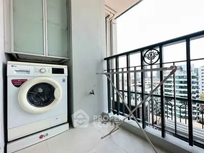 Modern balcony with washing machine and city view, perfect for urban living convenience.