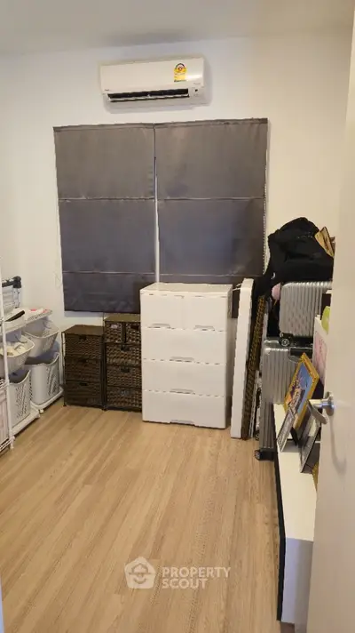 Cozy storage room with organized shelves and modern air conditioning unit.