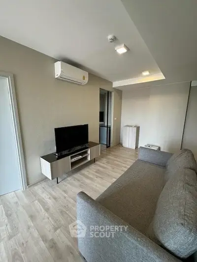 Modern living room with sleek furniture and air conditioning, perfect for comfortable living.
