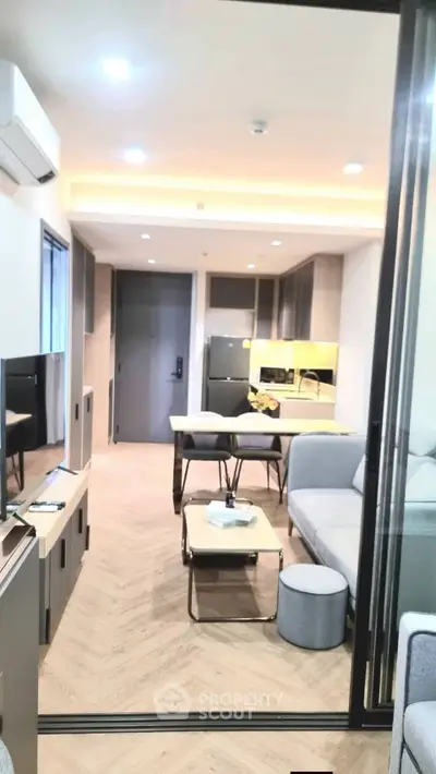 Modern living room with sleek furniture and open kitchen layout