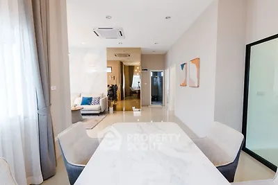Modern open-plan living and dining area with elegant decor and natural light.