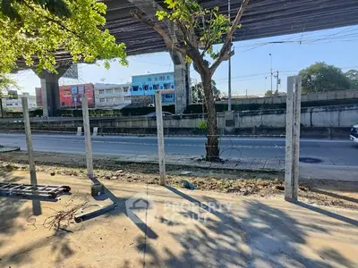 Urban roadside view with construction elements and overpass