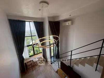 Modern loft with large window and stylish lighting, offering a stunning view.