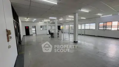 Spacious open-plan office space with ample natural light and modern fixtures.