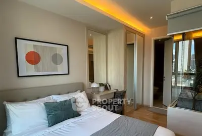 Modern bedroom with stylish decor and city view, featuring cozy bed and elegant lighting.