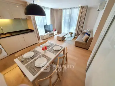 Modern open-layout living room with dining area and natural light