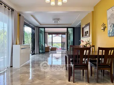 Spacious open-plan living and dining area with elegant decor and garden view.