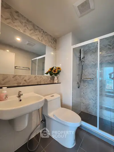 Modern bathroom with sleek shower and stylish tile accents