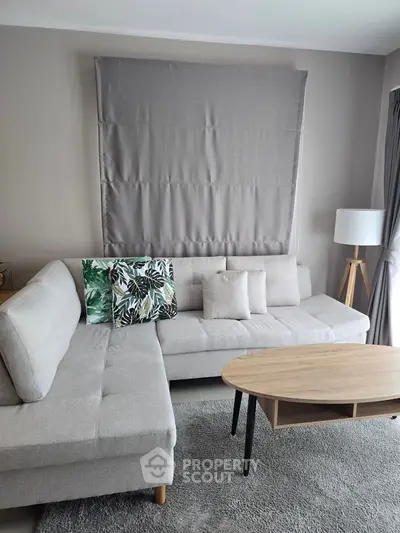 Modern living room with stylish gray sofa and wooden coffee table