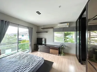 Spacious bedroom with large windows and modern furnishings