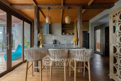 Stunning open-layout kitchen with rustic wooden beams and modern decor, perfect for entertaining.