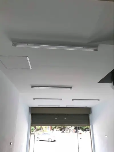 Spacious commercial space with high ceiling and natural light