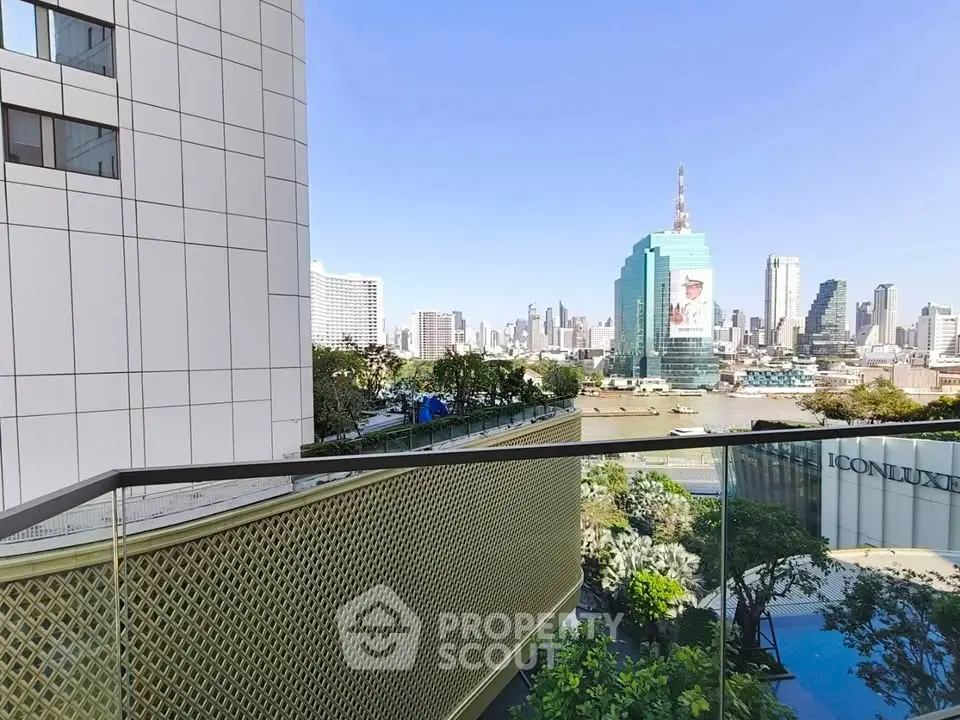 Stunning cityscape view from a modern balcony with glass railing, showcasing urban skyline and lush greenery.