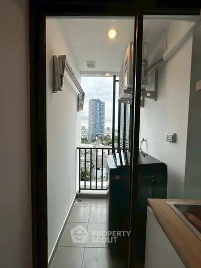Modern balcony with city view and laundry area in high-rise apartment