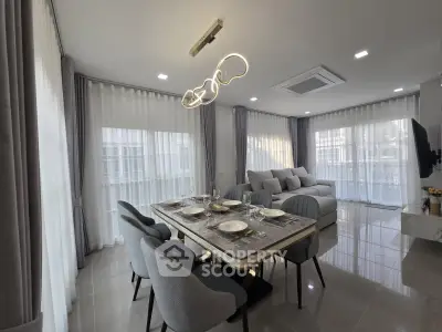 Elegant modern living room with dining area and stylish lighting
