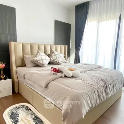 Luxurious bedroom with elegant decor and plush bedding in modern apartment.