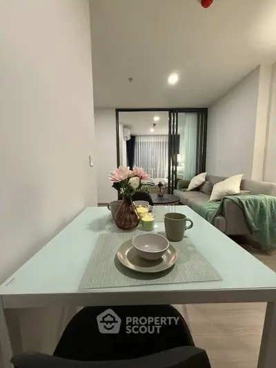 Modern living room with elegant dining setup and cozy seating area