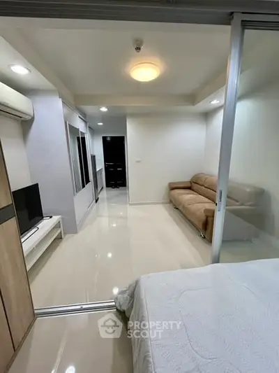 Modern living room with sleek design and cozy sofa in a stylish apartment.