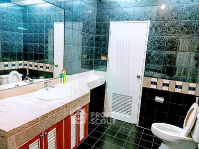 Spacious modern bathroom with elegant tile design and dual sinks