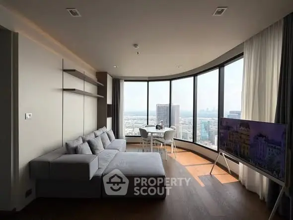 Luxurious modern living room with panoramic city views and stylish furnishings.