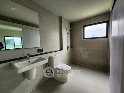 Modern minimalist bathroom with sleek fixtures and large window