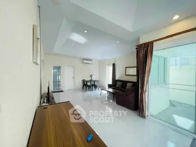 Spacious living room with modern furniture and large windows for natural light.