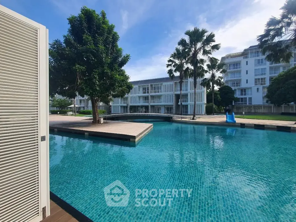 Luxurious residential complex with stunning pool and lush greenery