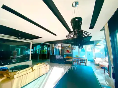 Luxurious modern living room with elegant chandelier and open layout, perfect for entertaining.