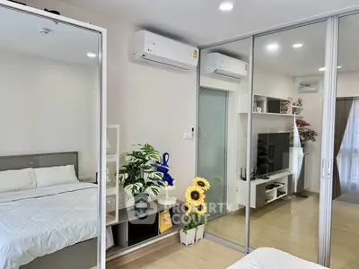 Modern bedroom with mirrored wardrobe and air conditioning units
