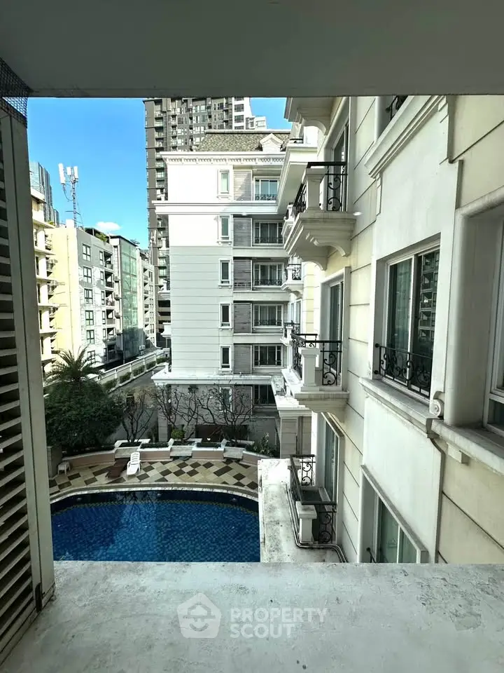 Luxurious apartment view with pool and elegant architecture in urban setting.