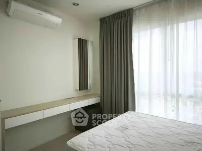 Modern bedroom with large window and air conditioning in a high-rise apartment.