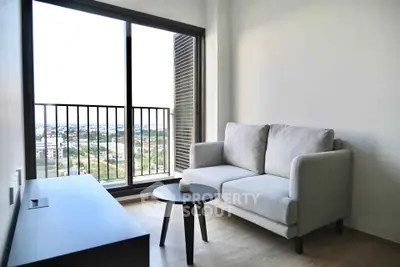 Cozy living room with a modern sofa and scenic balcony view in a stylish apartment.