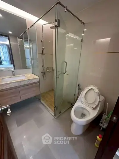 Modern bathroom with glass shower and sleek fixtures