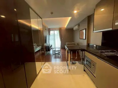 Modern open-layout kitchen and living room with sleek design and natural light