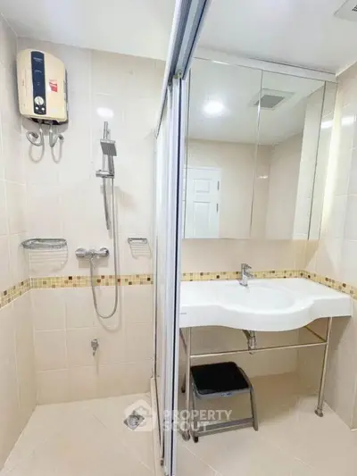 Modern bathroom with sleek shower and stylish sink in a contemporary apartment.