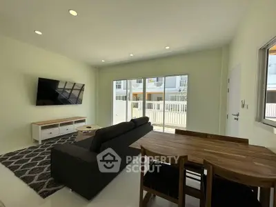 Spacious living room with modern furniture and large windows offering natural light.