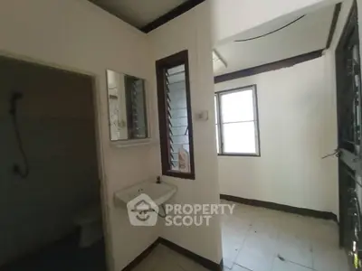 Cozy small bathroom with sink and window, ideal for compact living spaces.