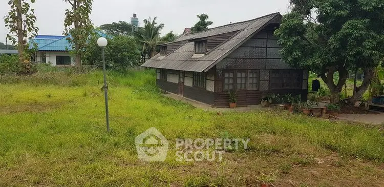 Charming rustic wooden house with lush green surroundings and serene ambiance.