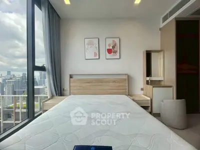 Modern bedroom with city view and stylish decor in high-rise apartment.