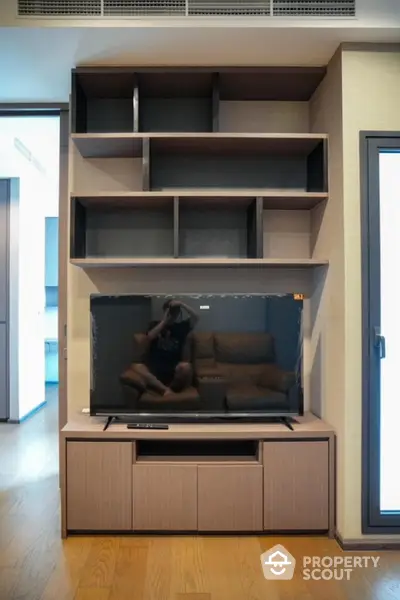 Modern living room with sleek TV unit and open shelving