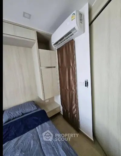 Modern bedroom with air conditioning and sleek wooden furnishings