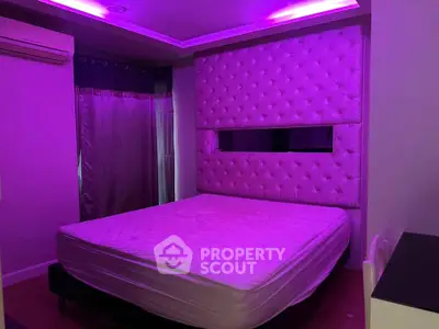 Luxurious bedroom with ambient purple lighting and tufted headboard