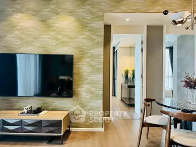 Modern living room with stylish decor and wall-mounted TV, featuring elegant dining area and open layout.