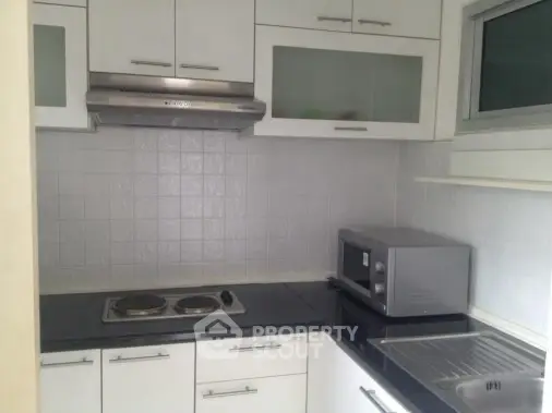 Modern kitchen with sleek cabinetry and built-in appliances