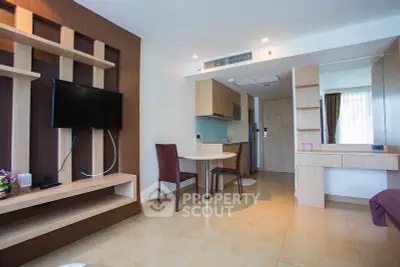 Modern living room with stylish furniture and open kitchen layout in a cozy apartment.