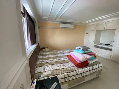 Spacious bedroom with modern design and ample natural light