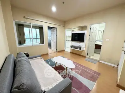 Spacious living room with modern decor and city view, perfect for relaxation.